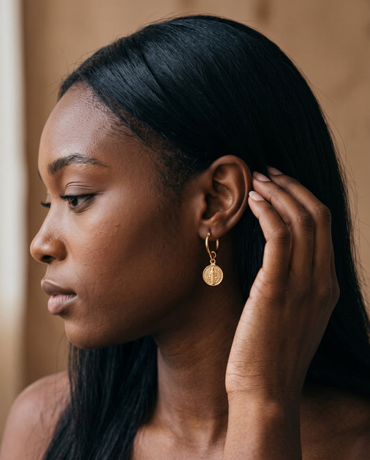 Gold Filled Saint Benedict Charm Hoop Earrings worn by a model
