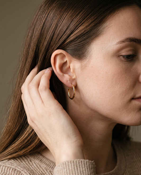 Gold Filled 18mm Mini Hoops worn by a model