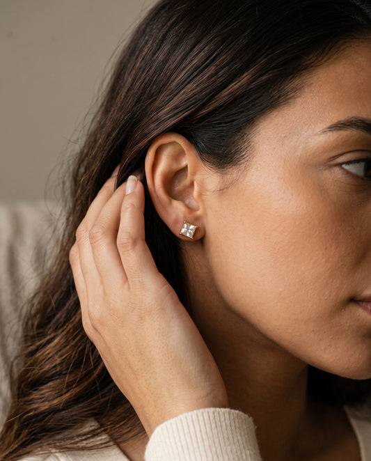 Gold Filled 7mm CZ Princess Cut Stud Earrings worn by a model