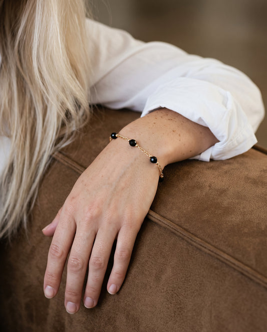 Gold Filled Black Crystal Figaro Bracelet worn by a model