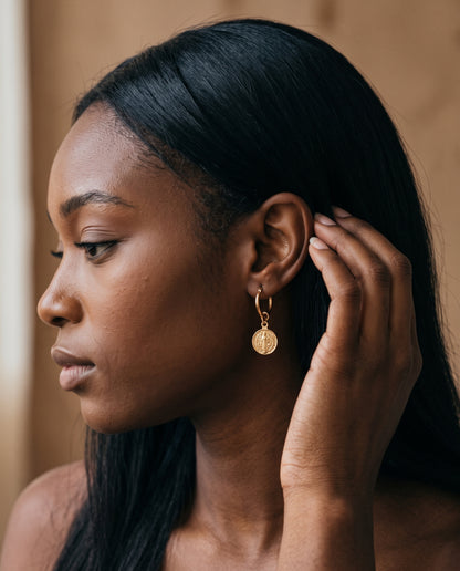 Gold Filled Saint Benedict Charm Hoop Earrings worn by a model