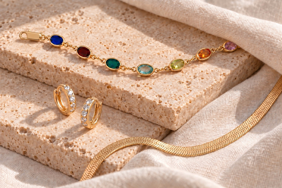 Oval gemstone bracelet with an oblong lobster clasp, mini hoops and herringbone necklace